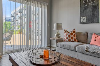 a living room with a couch and a sliding glass door to a patio